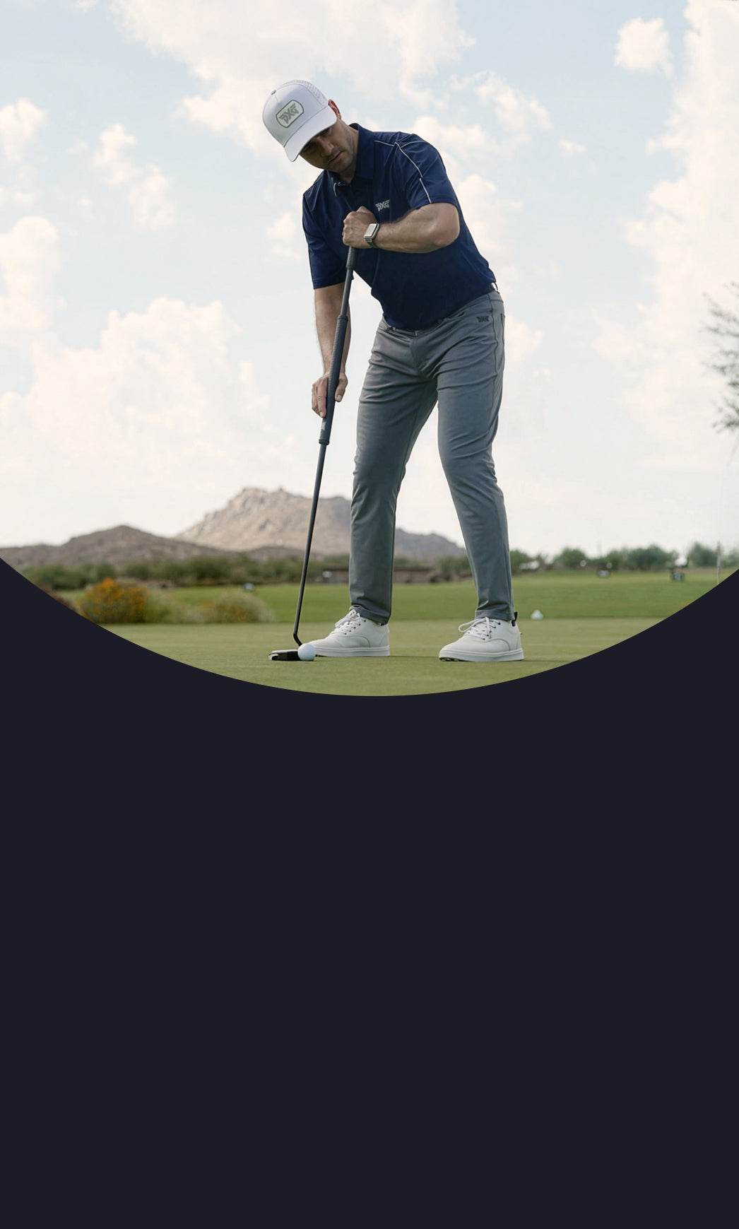 Golfer in action on a golf course with mountains in the background