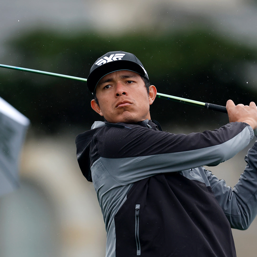 Pro August Nunez wearing a PXG Hat and swinging a golf club on a golf course.