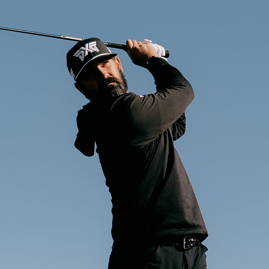 PGA Tour Pro Chad Ramey wearing PXG Golf Hat swinging against a blue sky