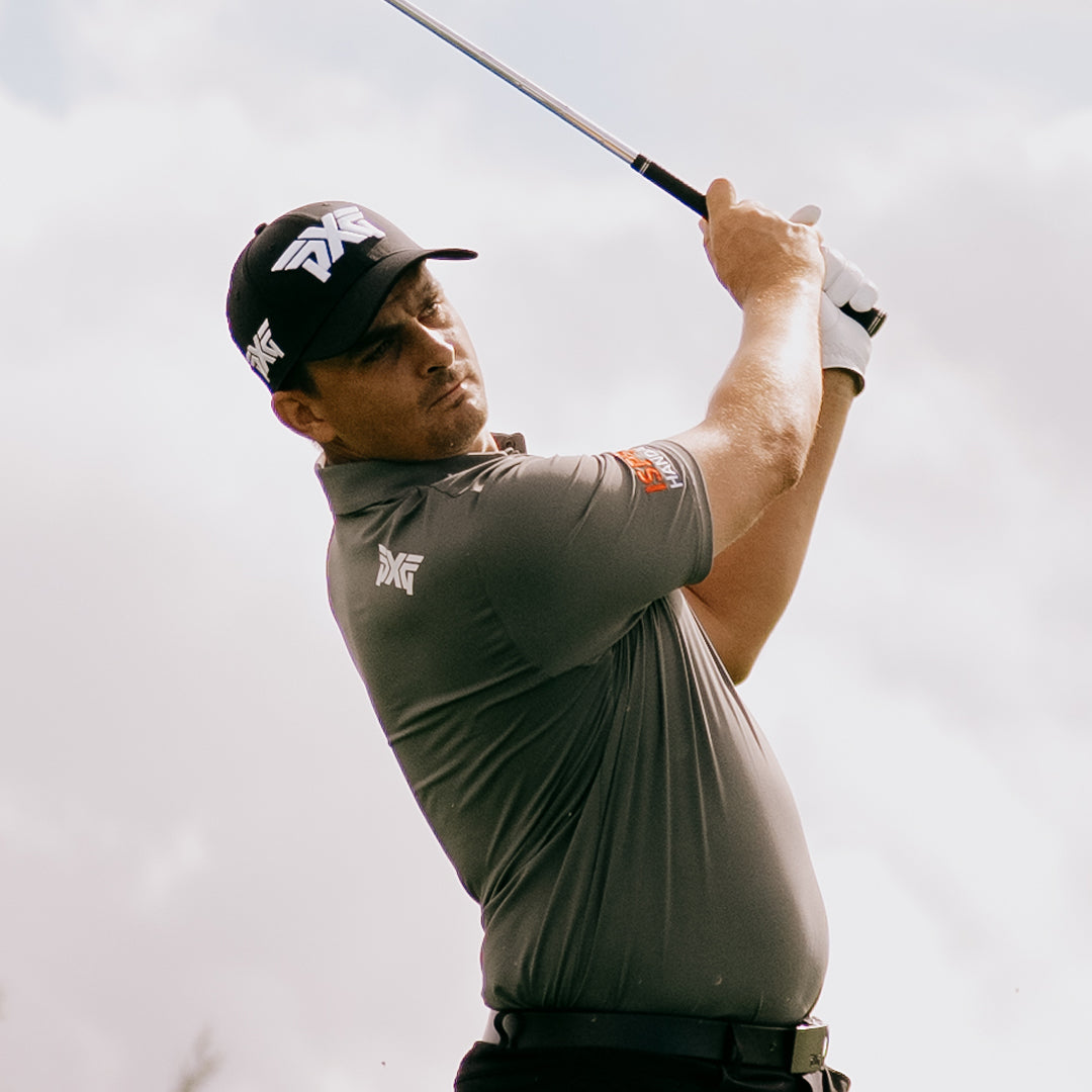 PGA Tour Pro Christiaan Bezuidenhout wearing a PXG Golf Hat against a white sky.