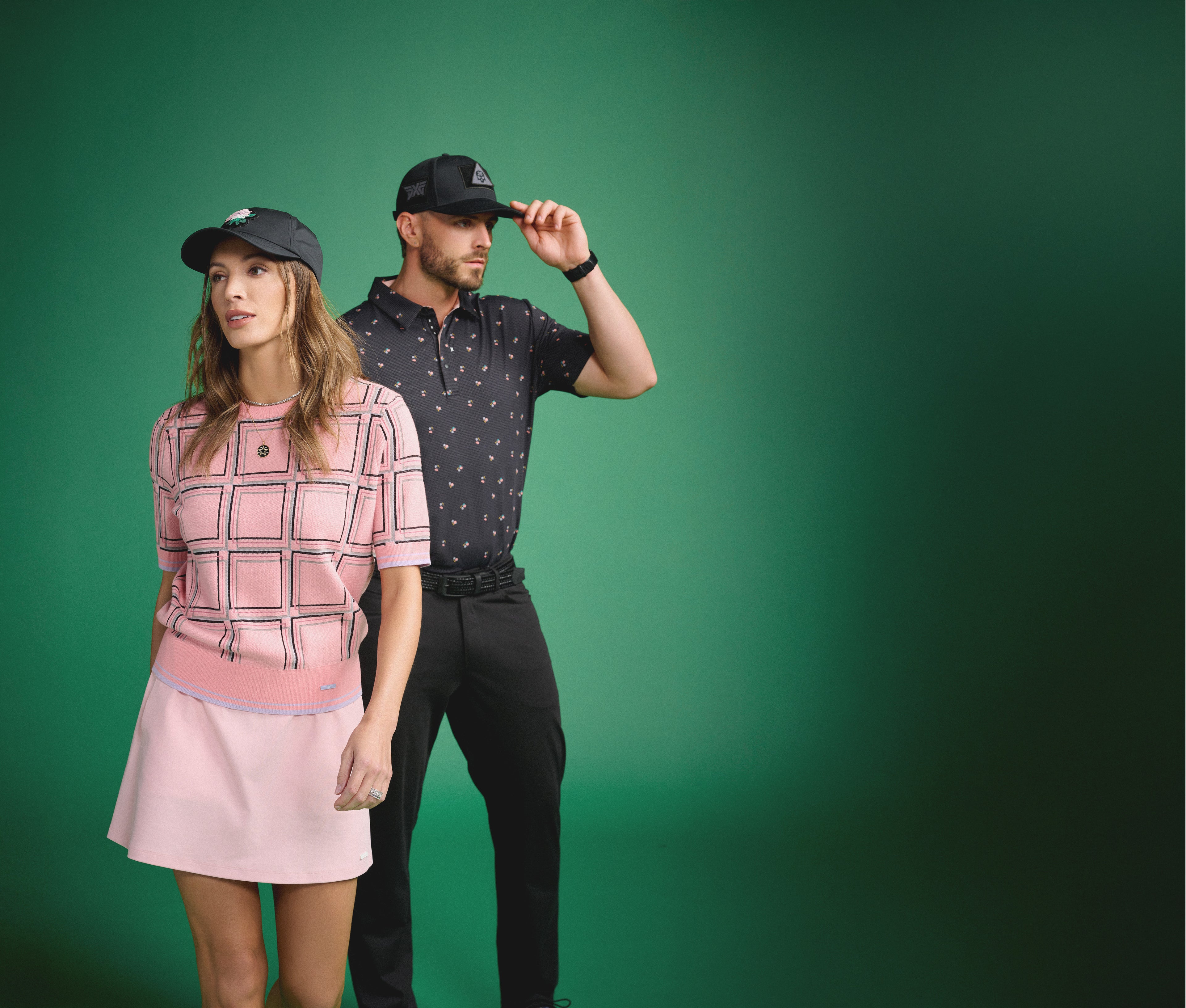 Man and woman wearing matching outfits against a green background